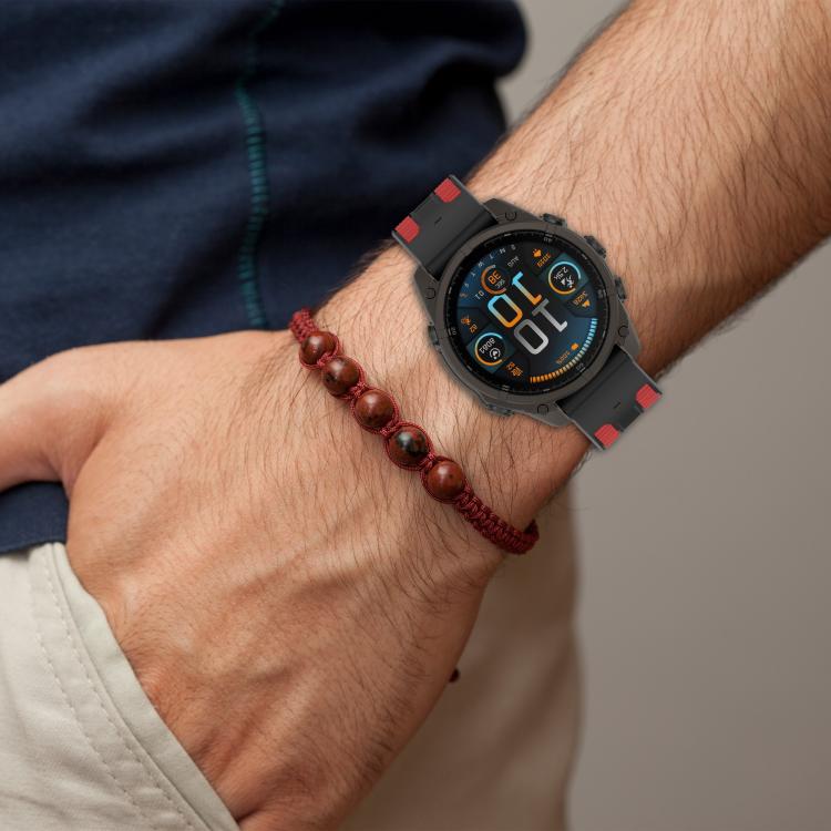 Black silicone watch band with red accents worn on wrist