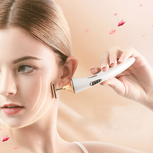 Electric facial massager holding a white and gold head against the cheek