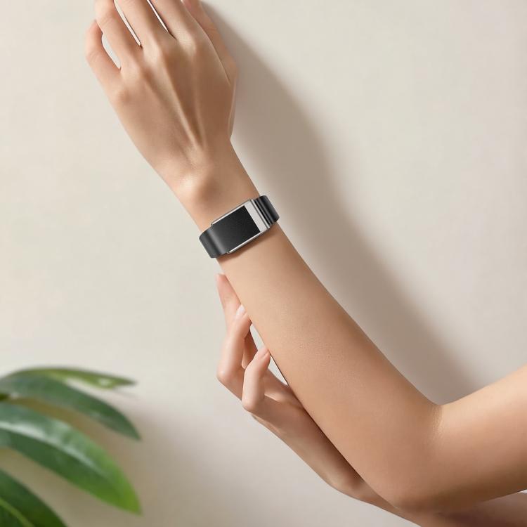 Black slim vegan leather watch band worn on the wrist with silver-tone hardware