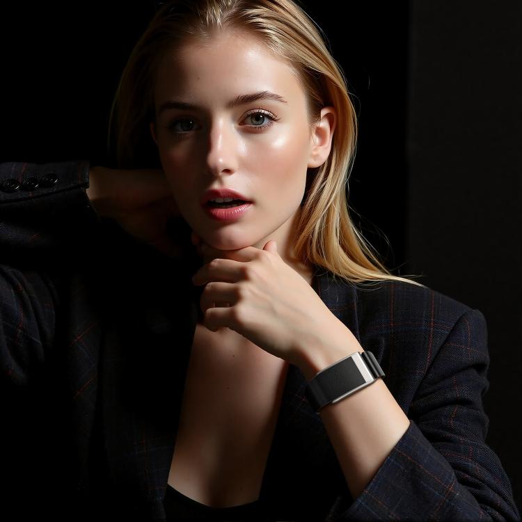 Black vegan leather watch band with silver-tone buckle worn on the wrist