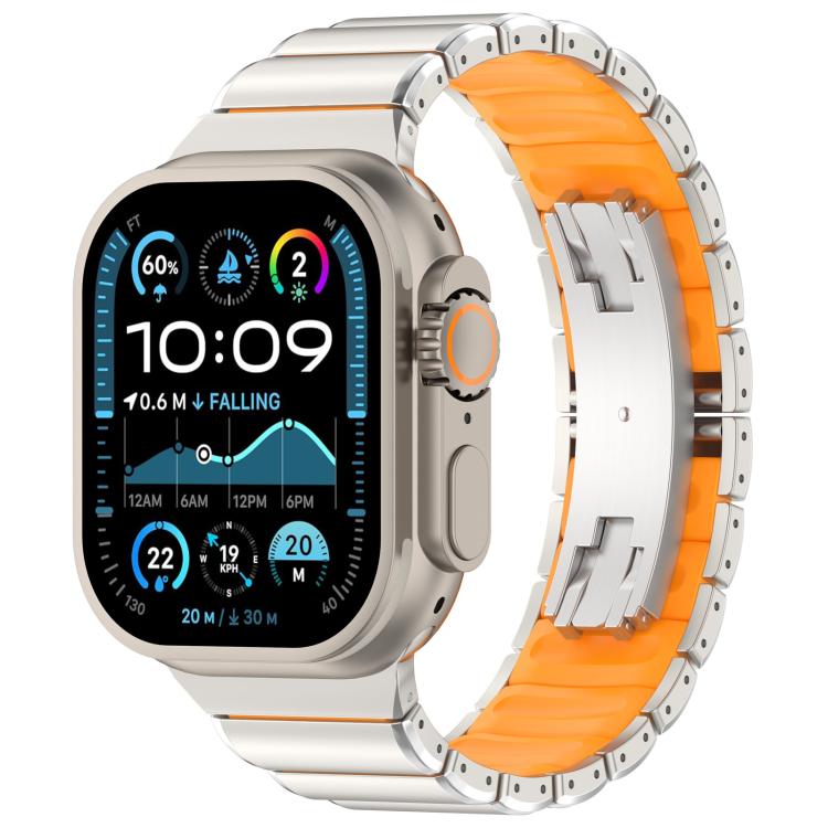 Silver titanium alloy watch band with orange silicone lining and folding clasp, shown on a watch
