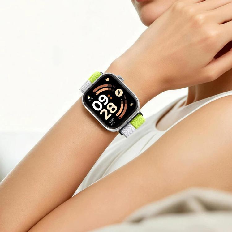 Lime green and white woven nylon watch band worn on a wrist