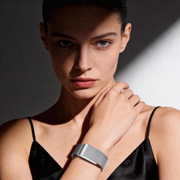 Silver magnetic mesh watch band worn on the wrist