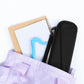 Black zippered hard case placed in a tote bag with hanging handle strap