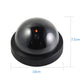 Black dome security camera with red LED indicator, front view