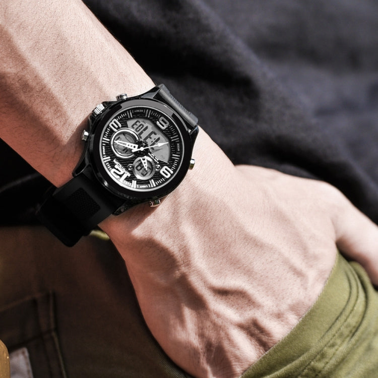 Digital wristwatch on wrist with black case and strap, dark dial with light subdials