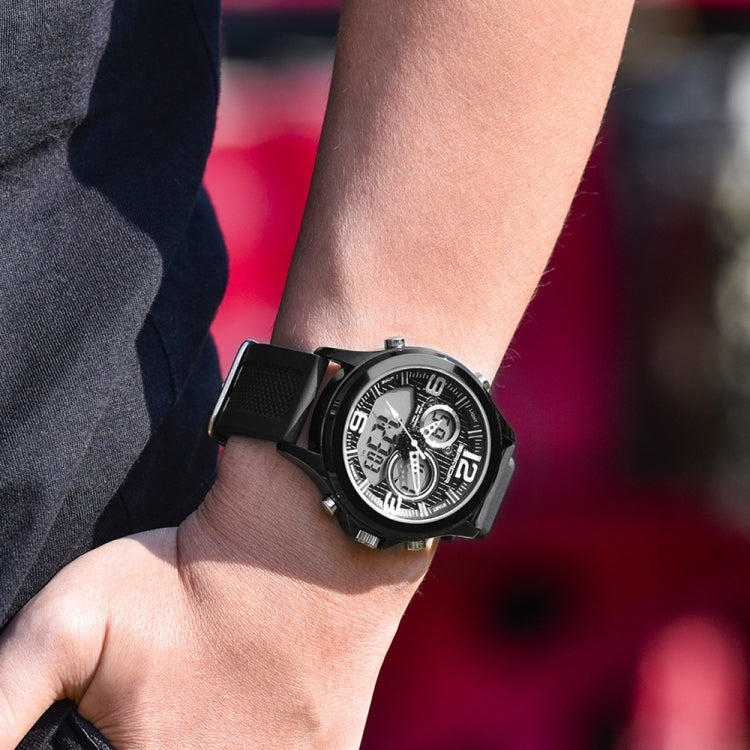 Digital wristwatch on wrist with black case and strap, dark dial with silver details