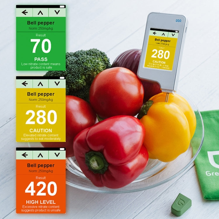Food safety nitrate detector showing result screen beside bell peppers in bowl