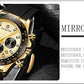 Gold-tone quartz watch with black silicone strap, close-up view of subdials