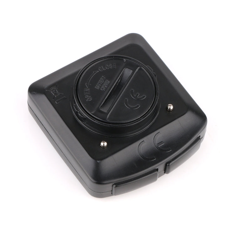 Wired bicycle computer back with battery dial, screws, and round sensor mount area