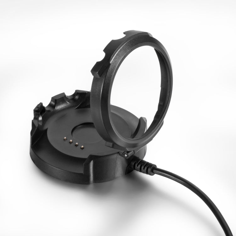 Close-up of black charging base with metal contacts and attached power cable
