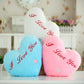 Heart-shaped plush glow pillows in white, blue, and pink with red 'I love You' text