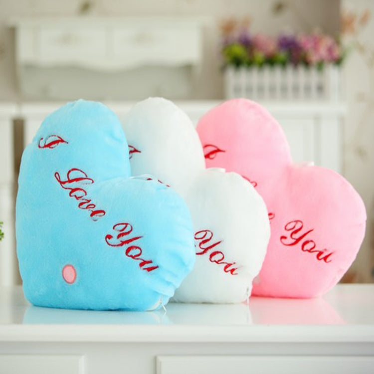 Heart-shaped plush glow pillows in blue, white, and pink with red 'I love You' text