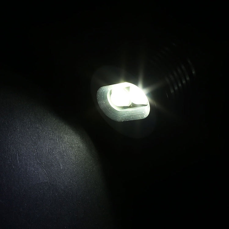 Single lit LED angel-eye bulb glowing white from a dark housing