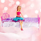 Mini pink plastic doll bed with purple floral mattress, lace skirt, decorative headboard; doll