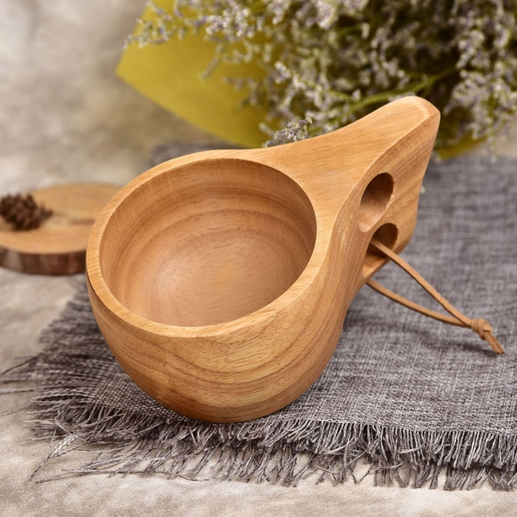Wooden drinking cup with round bowl, side openings, and brown cord tie