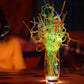 Cup filled with curved plastic straws in green and multicolor, looped tips