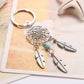 Silver dreamcatcher keychain with teal bead and three feather charms