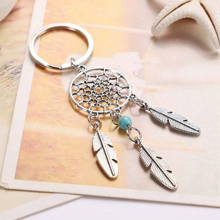 Silver dreamcatcher keychain with teal bead and three feather charms