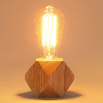 Wooden faceted night light with glowing vintage-style bulb on hexagonal base
