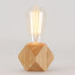 Wooden faceted night light with clear glass vintage bulb on hexagonal base
