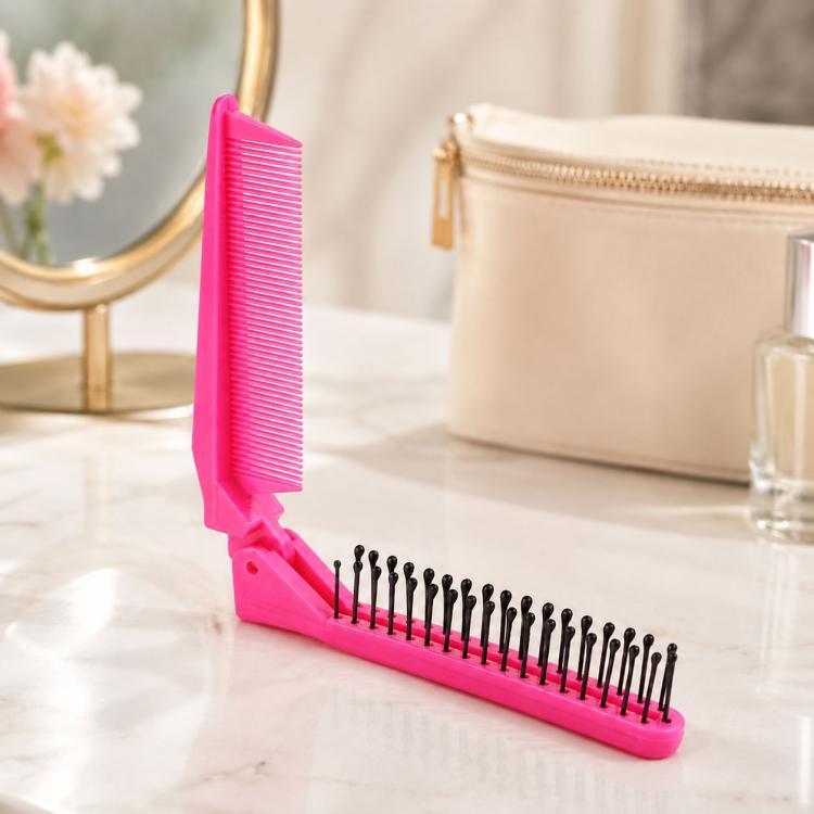 Pink folding travel hair comb with fine teeth and massage pins