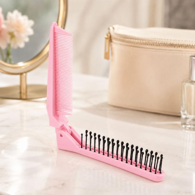 Light pink folding travel hair comb with fine teeth and massage pins