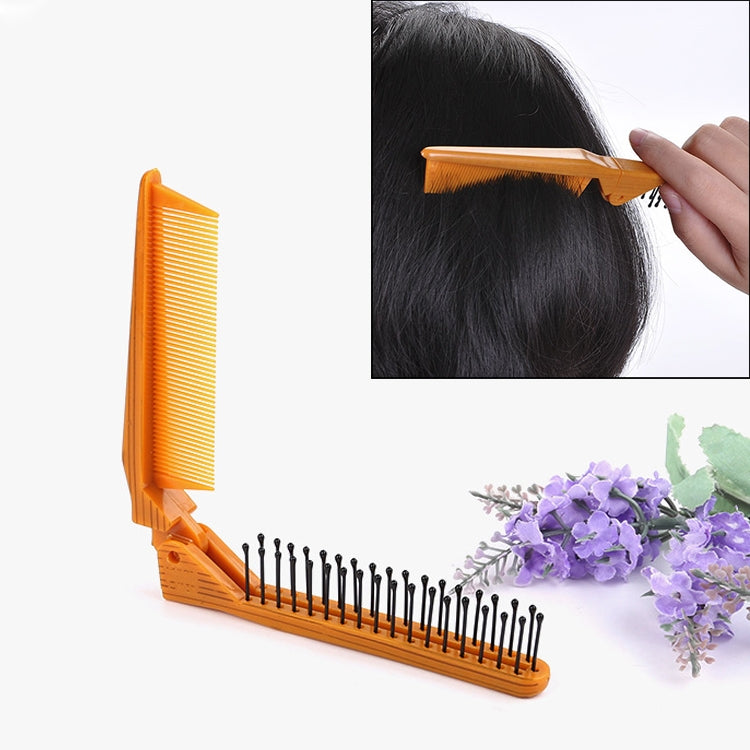 Orange folding comb with fine teeth and hinged handle for portable styling