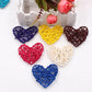 Multicolor rattan heart ornaments, woven straw hearts in assorted colors on display.