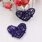 Dark blue rattan heart ornaments, two woven straw hearts with crisscross lattice.