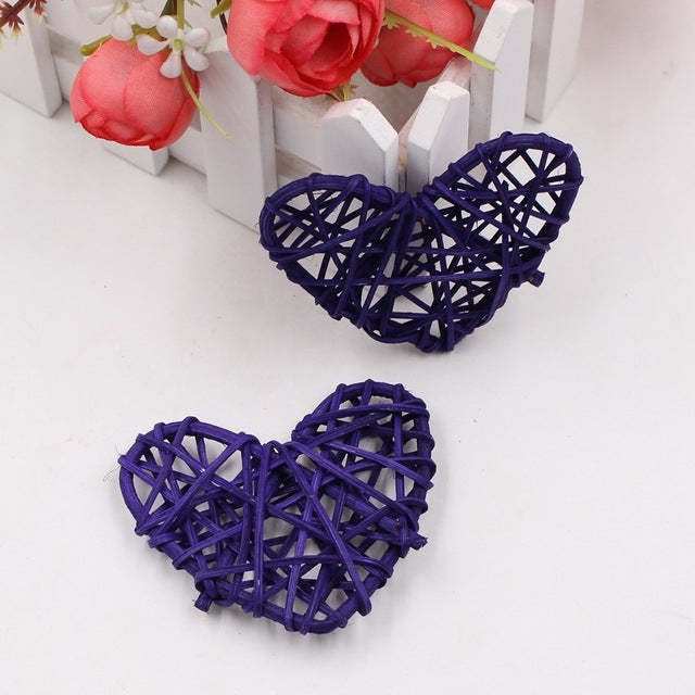Dark blue rattan heart ornaments, two woven straw hearts with crisscross lattice.