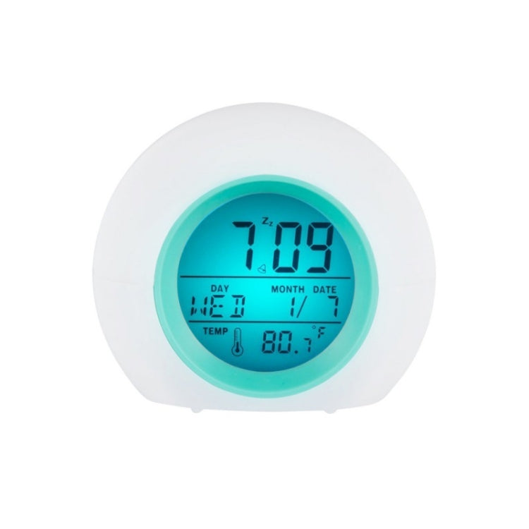 Round digital alarm clock with blue backlit screen, day month date and temp display
