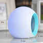 Round alarm clock with blue side ring, compact desktop size shown with measurements