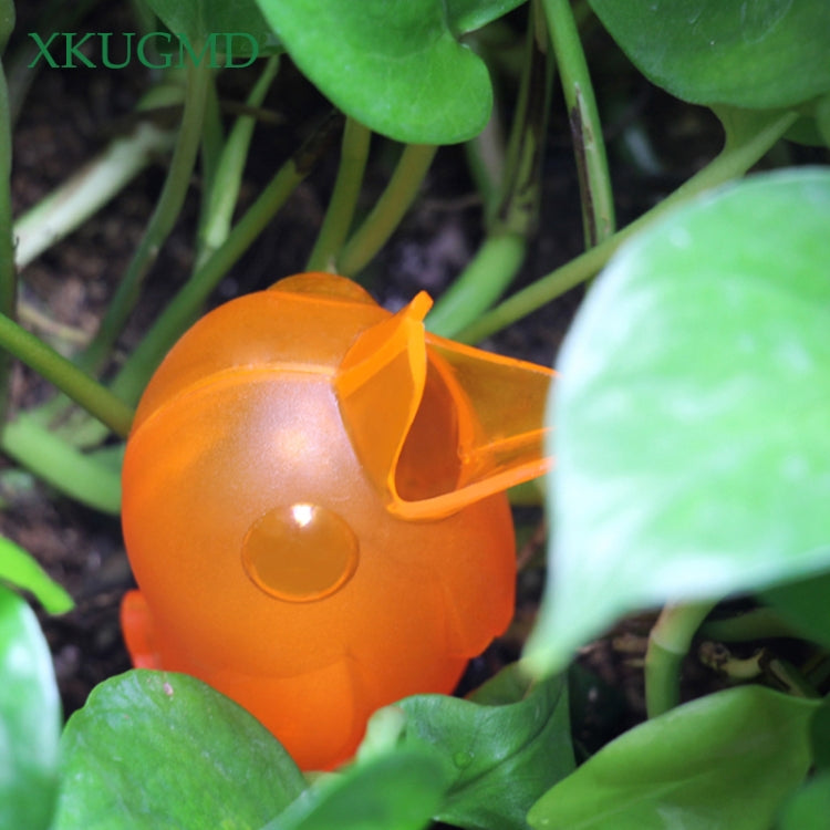 Orange bird sprinkler detail with round water outlet and beak nozzle