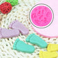 Pink silicone baby hand and foot mold with pastel molded figures
