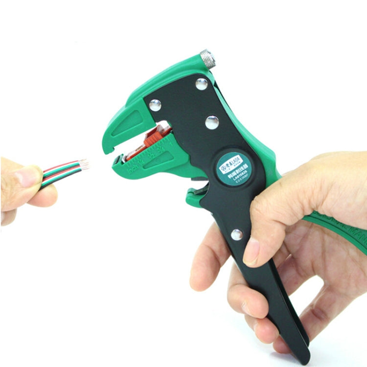Hands holding green and black duckbill wire stripping pliers