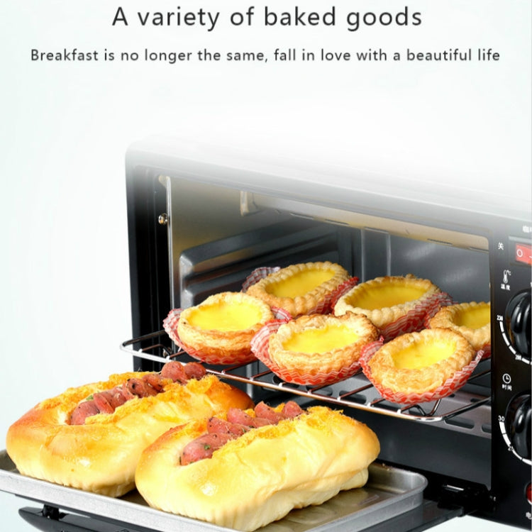 Black mini oven with baked tarts and bread rolls on the rack and tray