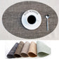 Oval placemat in grey fabric with cup and spoon on it; assorted color options shown below