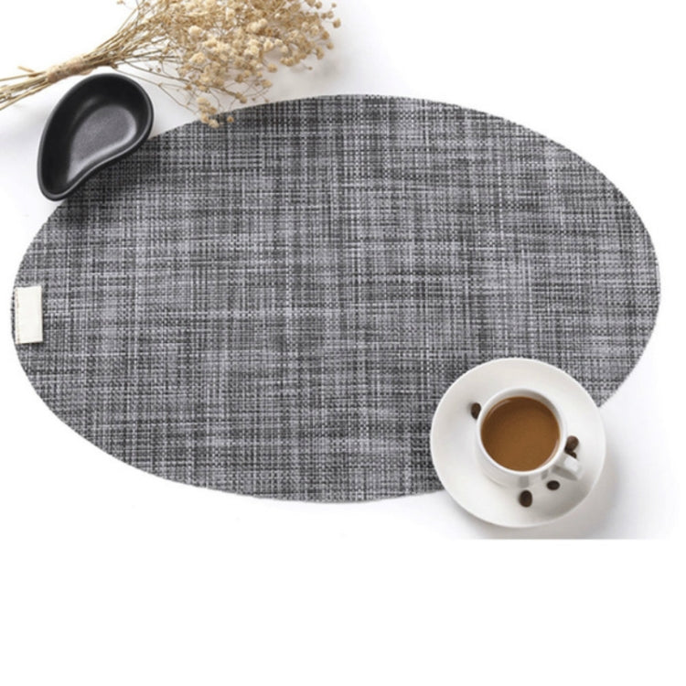 Oval grey plaid PVC table mat placemat pad with cup and saucer beside it