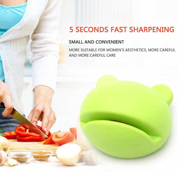 Green cartoon-style knife sharpener with rounded casing and side handle