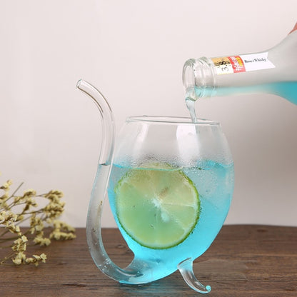 Clear glass juice mug with straw, filled with blue drink and lime slice