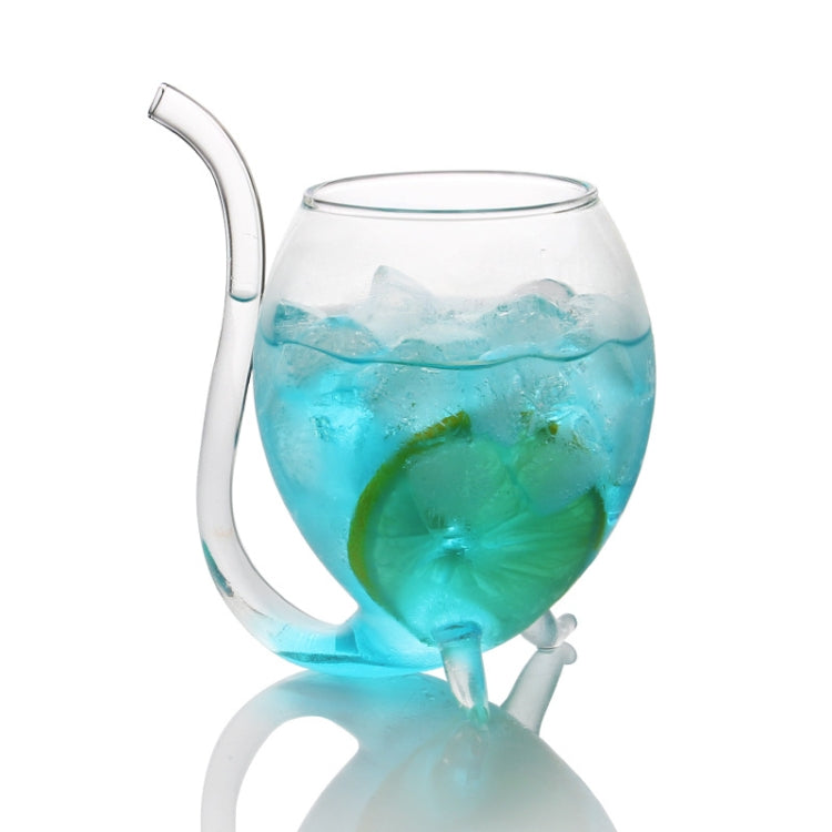 Clear glass juice mug with straw, filled with blue drink and green ice slice