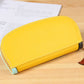 Yellow long zipper wallet clutch with smooth front panel and black stitched side trim