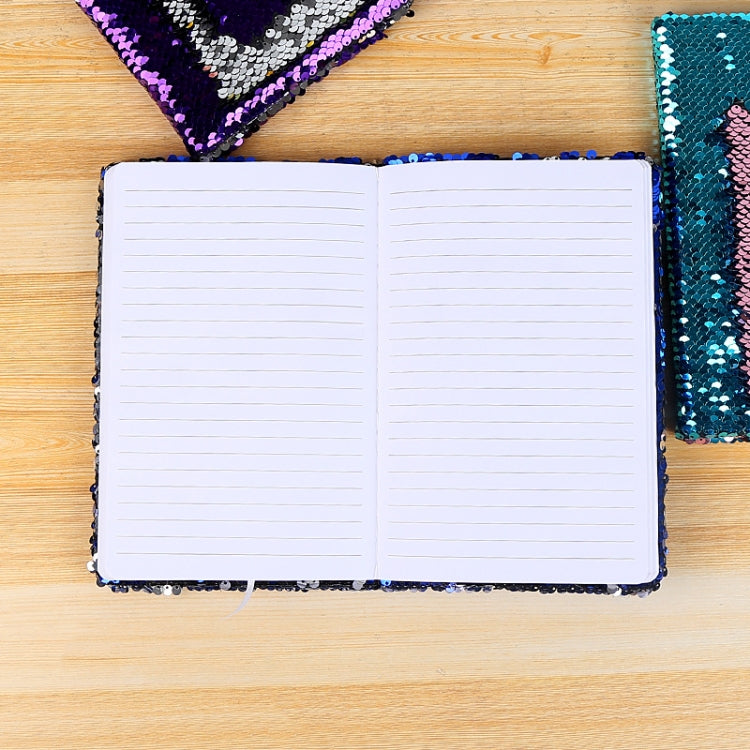 Open notebook with white lined pages and dark sequin border on cover