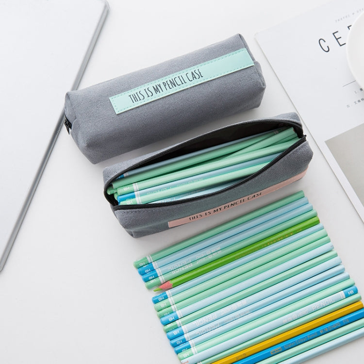 Open gray pencil case with mint front label, zipper top and pencils inside
