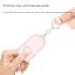 Pink keychain alarm flashlight, hand pulling safety ring above SOS button