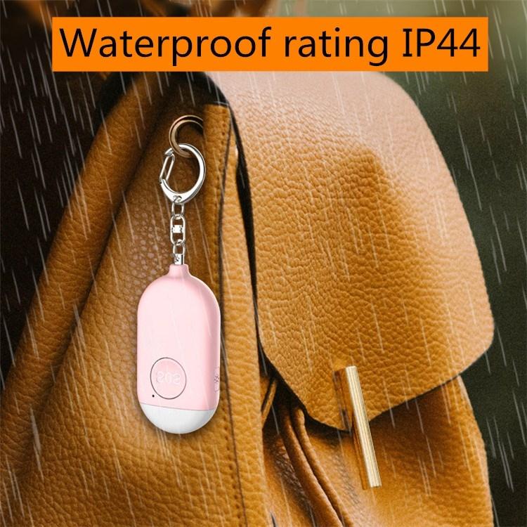 Pink keychain personal alarm flashlight hanging from keyring on leather bag