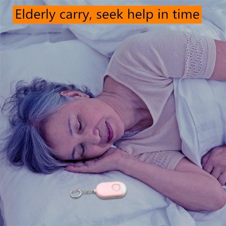 Pink keychain personal alarm flashlight placed on bed near sleeping person