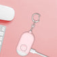 Pink personal safety alarm keychain with circular SOS button and metal clip