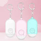 Set of personal safety alarm keychains in white, pink, and light blue with SOS buttons